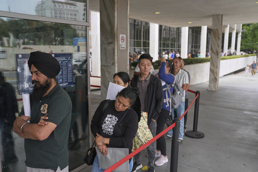 People line up outside the Los Angeles Federal Building in Los Angeles, housing the U.S. Immigration and Customs Enforcement (ICE) and U.S. Citizenship and Immigration Services (USCIS) on Wednesday, June 25, 2025. (AP Photo/Damian Dovarganes)