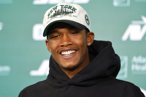 FILE - New York Jets wide receiver Garrett Wilson answers questions during a news conference following NFL football practice, May 21, 2025, in Florham Park, N.J. (AP Photo/Noah K. Murray, File)
