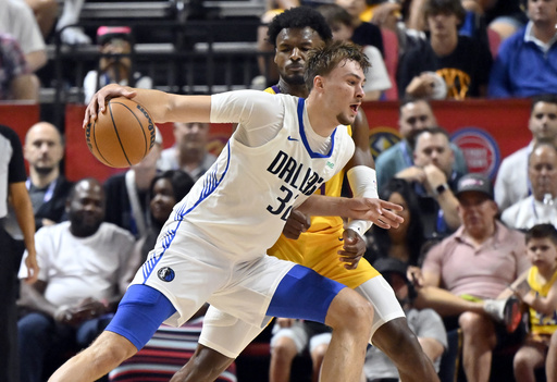 Dallas Mavericks forward Cooper Flagg (32) drives the ball against Los Angeles Lakers guard Bronny James (9) during the first half of an NBA summer league basketball game Thursday, July 10, 2025, in Las Vegas. (AP Photo/David Becker)