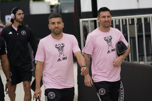 FILE - Inter Miami defender Jordi Alba, left, and forward Lionel Messi chat as they arrive before the start of an MLS soccer match against Toronto FC, Wednesday, Sept. 20, 2023, in Fort Lauderdale, Fla. (AP Photo/Wilfredo Lee, File)