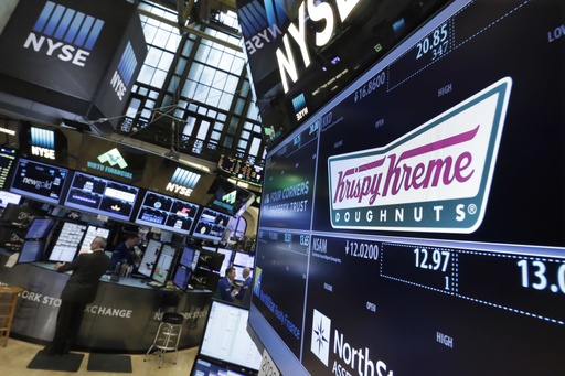 FILE - The Krispy Kreme logo appears above its trading post on the floor of the New York Stock Exchange, Monday, May 9, 2016. (AP Photo/Richard Drew, File)
