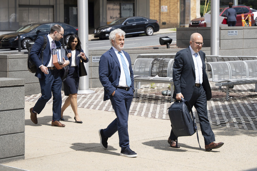 Former White House Chief of Staff Jeffrey Zients, center, arrives at the Court of Chancery on Wednesday, July 16, 2025, in Wilmington, Del. (AP Photo/Mingson Lau)