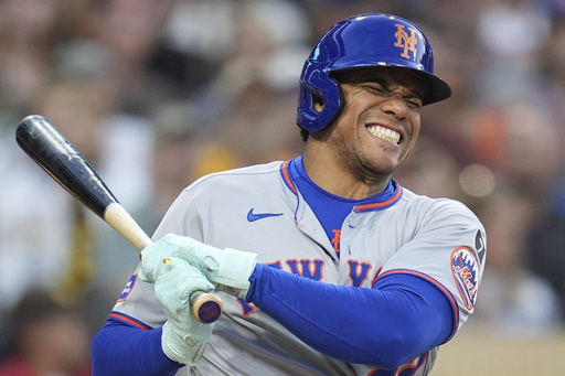 New York Mets' Juan Soto reacts after fouling a ball off his leg while batting during the fourth inning of a baseball game against the San Diego Padres Tuesday, July 29, 2025, in San Diego. (AP Photo/Gregory Bull)