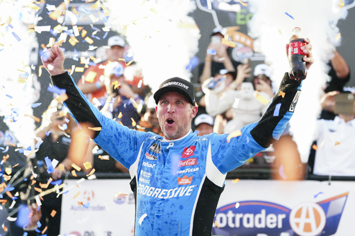 Denny Hamlin celebrates in Victory Lane after winning a NASCAR Cup Series auto race at Dover Motor Speedway, Sunday, July 20, 2025, in Dover, Del. (AP Photo/Derik Hamilton)