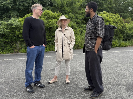 Agog Executive Director Chip Giller, left, philanthropist Wendy Schmidt and Kinfolk Tech co-founder Idris Brewster, right, tour Brooklyn Bridge Park in New York City on June 7, 2025. (AP Photo/James Pollard)