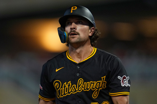 Pittsburgh Pirates' Adam Frazier walks back to the dugout after striking out during the ninth inning of a baseball game against the Minnesota Twins, Friday, July 11, 2025, in Minneapolis. (AP Photo/Abbie Parr)