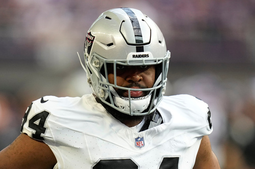 FILE - Las Vegas Raiders defensive tackle Christian Wilkins (94) warms up before an NFL preseason football game against the Minnesota Vikings, Saturday, Aug. 10, 2024, in Minneapolis. (AP Photo/Charlie Neibergall, File)
