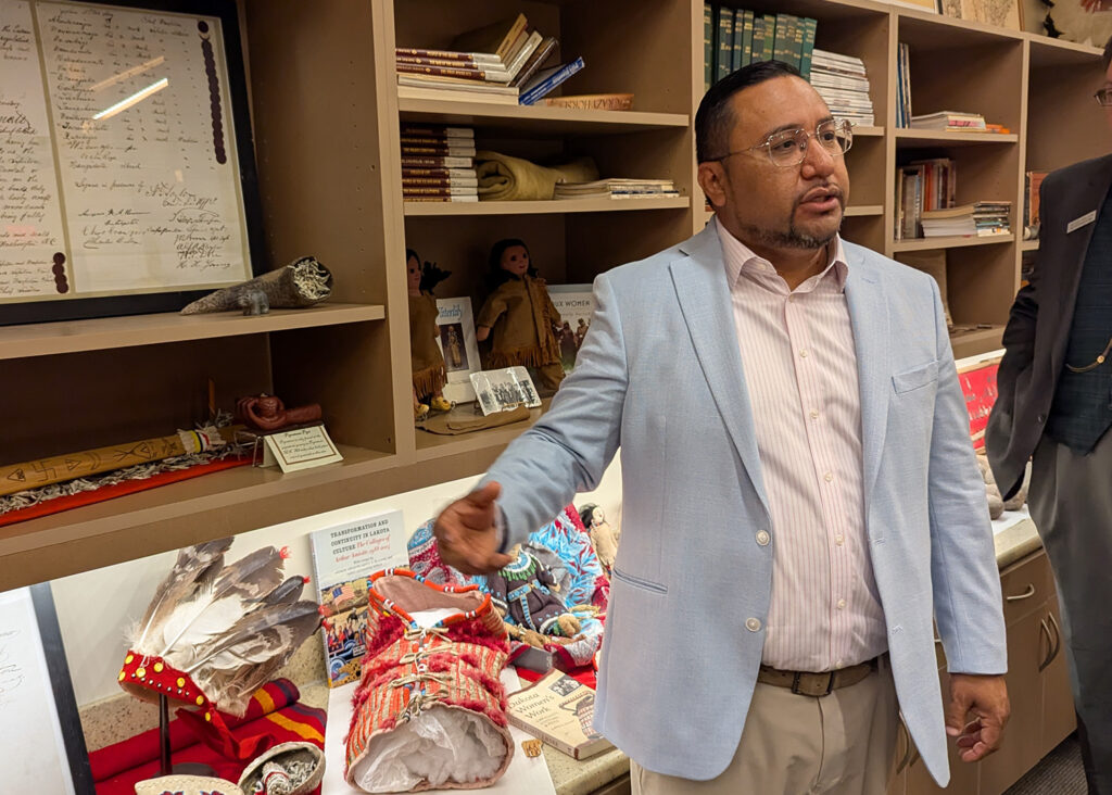 J. Garret Renville, chairman of the Sisseton-Wahpeton Oyate, speaks to visitors from the State-Tribal Relations Committee about the tribe's artifacts on July 31, 2025. (John Hult/South Dakota Searchlight)