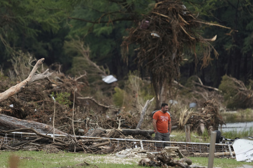 A man surveys debris and flood damage along the Guadalupe River, Sunday, July 13, 2025, in Kerrville, Texas. (AP Photo/Eric Gay)