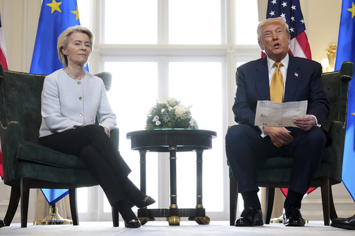 President Donald Trump reads from a paper and European Commission President Ursula von der Leyen listens after reaching a trade deal between the U.S. and the EU at the Trump Turnberry golf course in Turnberry, Scotland Sunday, July 27, 2025. (AP Photo/Jacquelyn Martin)