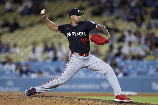 Minnesota Twins relief pitcher Jhoan Duran throws a pitch during the ninth inning of a baseball game against the Los Angeles Dodgers Tuesday, July 22, 2025, in Los Angeles. (AP Photo/Eric Thayer)