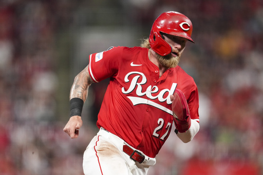 Cincinnati Reds' Jake Fraley rounds third base and scores on a double hit by TJ Friedl during the sixth inning of a baseball game against the Minnesota Twins, Tuesday, June 17, 2025, in Cincinnati. (AP Photo/Jeff Dean)