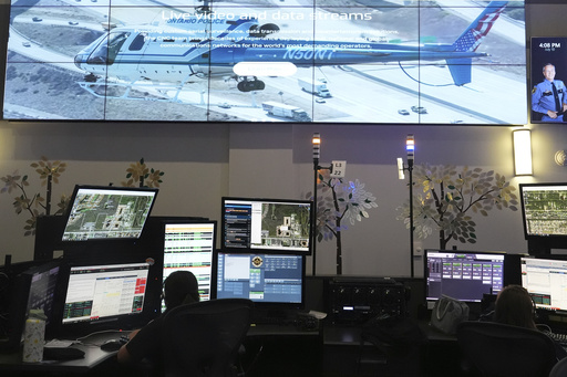 Dispatchers work emergency calls at the Collier County Emergency Services Center, Friday, July 11, 2025, in Naples, Fla. (AP Photo/Marta Lavandier)