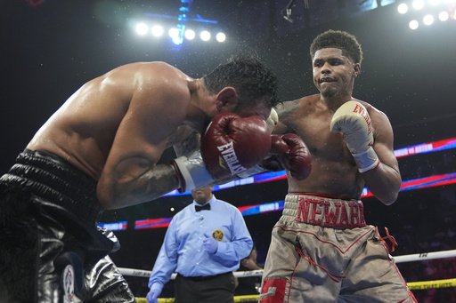 FILE - Shakur Stevenson, right, punches Germany's Artem Harutyunyan during the ninth round of a WBC world lightweight championship boxing match Sunday, July 7, 2024, in Newark, N.J. Stevenson won the fight. (AP Photo/Frank Franklin II, File)