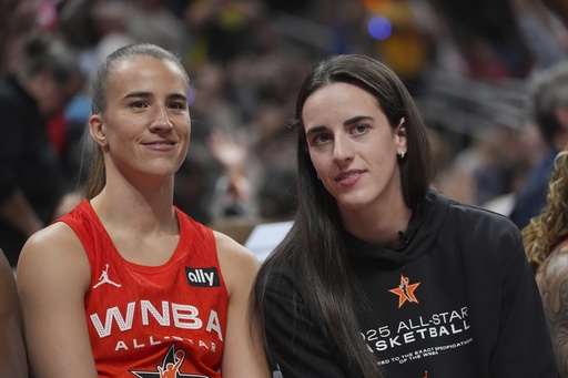 New York Liberty's Sabrina Ionescu, left, talks with Indiana Fever's Caitlin Clark during the second half of a WNBA All-Star basketball game against Team Collier, Saturday, July 19, 2025, in Indianapolis. (AP Photo/Michael Conroy)