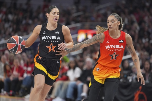 Los Angeles Sparks's Kelsey Plum, left, goes to the basket against Seattle Storm's Gabby Williams during the second half of a WNBA All-Star basketball game, Saturday, July 19, 2025, in Indianapolis. (AP Photo/Michael Conroy)