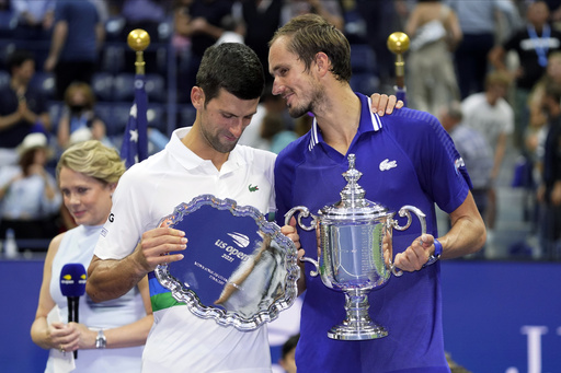FILE- Daniil Medvedev, of Russia, right, talks with Novak Djokovic, of Serbia, after defeating Djokovic in the men's singles final of the US Open tennis championships, Sept. 12, 2021, in New York. (AP Photo/John Minchillo, File)