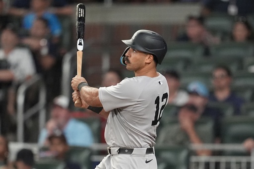 New York Yankees' Trent Grisham (12) hits a grand slam home run against the Atlanta Braves in the ninth inning of a baseball game, Saturday, July 19, 2025, in Atlanta. (AP Photo/Mike Stewart)