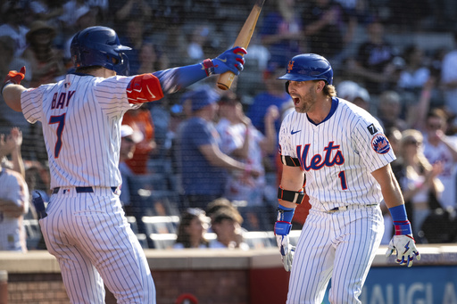 New York Mets' Jeff McNeil (1) celebrates with Brett Baty (7) after scoring on his two-run home run during the seventh inning of a baseball game against the New York Yankees, Friday, July 4, 2025, in New York. (AP Photo/Angelina Katsanis)