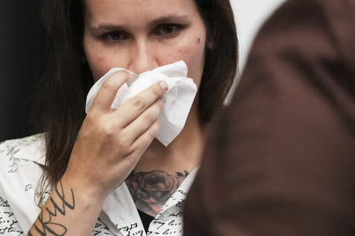 One of sexual assault survivor Kate-Lynn (first name only), wipes his face after talking to media during a news conference in Chicago, Wednesday, July 16, 2025. (AP Photo/Nam Y. Huh)