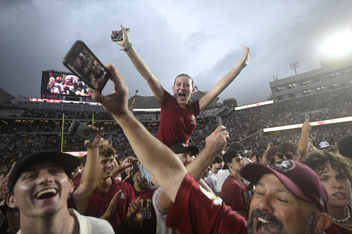 Florida State fans celebrate on the field after a win against Alabama in an NCAA college football game, Saturday, Aug. 30, 2025, in Tallahassee, Fla. (AP Photo/Phelan M. Ebenhack)