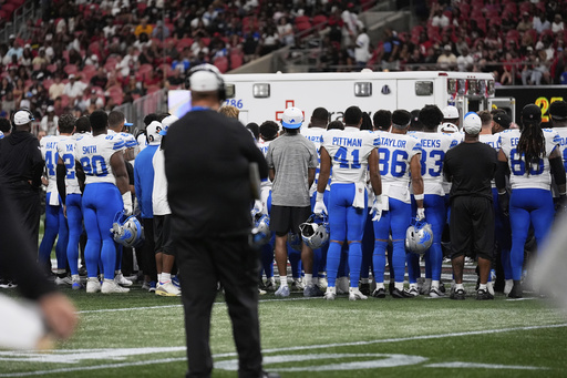 Detroit Lions players stand on the field after safety Morice Norris was injured during the second half of an NFL preseason football game against the Atlanta Falcons Friday, Aug. 8, 2025, in Atlanta. (AP Photo/Brynn Anderson)