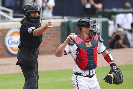Home plate umpire Jen Pawol calls a strike during the first inning of a baseball game between the Miami Marlins and Atlanta Braves, Sunday, Aug. 10, 2025, in Atlanta. (AP Photo/Colin Hubbard)