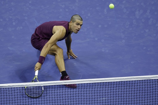 Carlos Alcaraz, of Spain, returns a shot to Reilly Opelka, of the United States, during the first round of the U.S. Open tennis championships, Monday, Aug. 25, 2025, in New York. (AP Photo/Adam Hunger)