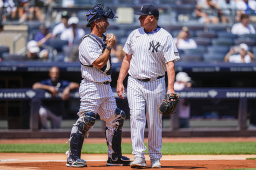 Former New York Yankees' Roger Clemens (22) and Jorge Posada (20) speak during the first inning of the Yankees Old-Timers' Day Game before a baseball game against the Houston Astros, Saturday, Aug. 9, 2025, in New York. (AP Photo/Yuki Iwamura)