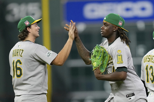 Athletics' Nick Kurtz (16) and Lawrence Butler celebrate after a baseball game against the Houston Astros Saturday, July 26, 2025, in Houston. (AP Photo/David J. Phillip)