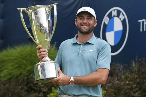 Scottie Scheffler holds the trophy after winning the BMW Championship golf tournament Sunday, Aug. 17, 2025, in Owings Mills, Md. (AP Photo/Stephanie Scarbrough)
