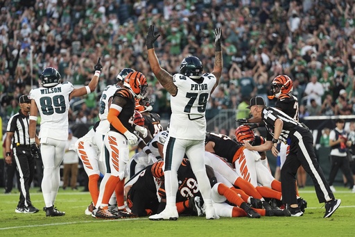 Philadelphia Eagles wide receiver Johnny Wilson (89) and Eagles offensive tackle Matt Pryor (79) celebrate a touchdown by teammate quarterback Tanner McKee (16) during the first half of an NFL preseason football game against the Cincinnati Bengals Thursday, Aug. 7, 2025, in Philadelphia. (AP Photo/Matt Rourke)