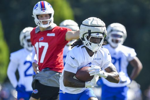 Buffalo Bills running back James Cook (4) takes a handoff from quarterback Josh Allen (17) during practice at the team’s NFL football training camp, Wednesday, July 23, 2025, in Pittsford, N.Y. (AP Photo/Adrian Kraus)