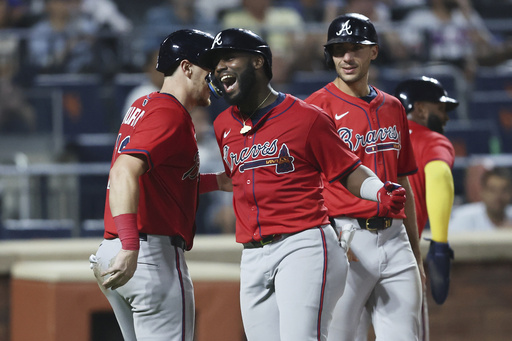 Atlanta Braves' Michael Harris II, center, celebrates his grand slam during the fourth inning of a baseball game against the New York Mets, Wednesday, Aug. 13, 2025, in New York. (AP Photo/Heather Khalifa)