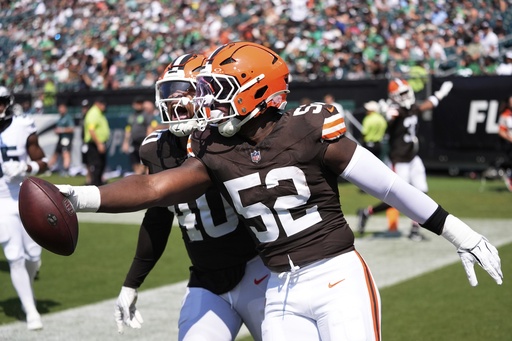 Cleveland Browns defensive end KJ Henry (52) celebrates his interception for a touchdown with Browns linebacker Nathaniel Watson (40) during the second half of an NFL preseason football game against the Philadelphia Eagles on Saturday, Aug. 16, 2025, in Philadelphia. (AP Photo/Chris Szagola)