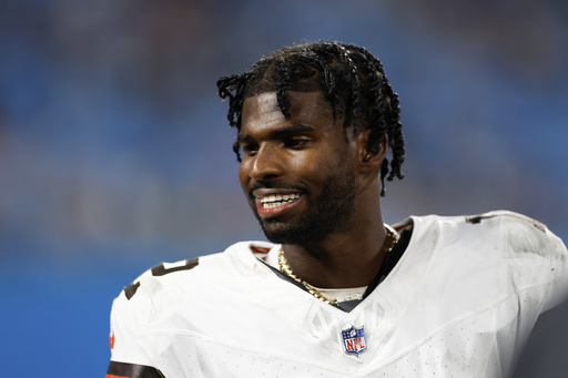 Cleveland Browns quarterback Shedeur Sanders watches during the first half of a preseason NFL football game against the Carolina Panthers on Friday, Aug. 8, 2025, in Charlotte, N.C. (AP Photo/Rusty Jones)