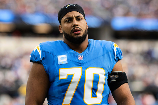 FILE - Los Angeles Chargers offensive tackle Rashawn Slater (70) walks on the field before an NFL football game against the Tampa Bay Buccaneers, Dec. 15, 2024, in Inglewood, Calif. (AP Photo/Kyusung Gong, File)