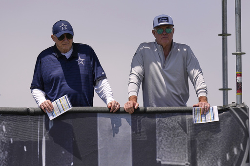 Jerry Jones, left, Dallas Cowboys owner, president, and general manager stands with his son Stephen Jones, Cowboys co-owner, executive vice president, CEO, and director of player personnel during training camp Tuesday, July 22, 2025, in Oxnard, Calif. (AP Photo/Mark J. Terrill)