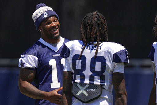 Dallas Cowboys defensive end Micah Parsons, left, talks with wide receiver CeeDee Lamb during training camp Thursday, July 31, 2025, in Oxnard, Calif. (AP Photo/Mark J. Terrill)
