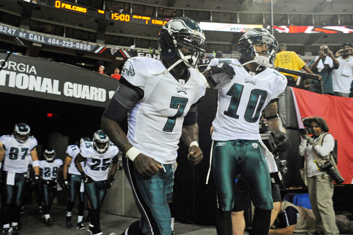 FILE- Philadelphia Eagles quarterback Michael Vick (7) wide receiver DeSean Jackson (10) lead players onto the field prior to an NFL football game against the Atlanta Falcons at the Georgia Dome in Atlanta on Sunday, Sept. 18, 2011. (AP Photo/John Amis, File)