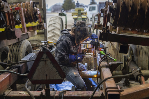 Devon Wells, a junior at Perry Central High School, welds a metal calf feeder at Halo Farms, where he works, on March 12, 2025, in Perry, N.Y. (AP Photo/Lauren Petracca)