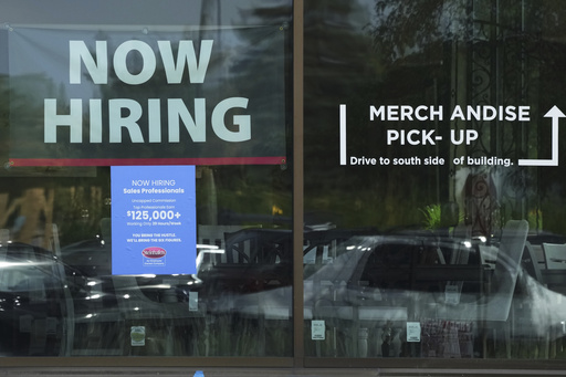 Now hiring sign is displayed at a retail store in Vernon Hills, Ill., Thursday, August. 7, 2025. (AP Photo/Nam Y. Huh)