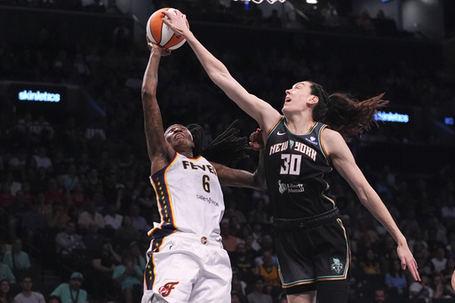 New York Liberty's Breanna Stewart (30) blocks a shot by Indiana Fever's Natasha Howard (6) during the second half of a WNBA basketball game Wednesday, July 16, 2025, in New York. (AP Photo/Frank Franklin II)
