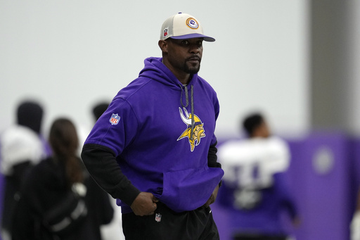 FILE - Minnesota Vikings defensive coordinator Brian Flores stands on the field during an NFL football workout in Eagan, Minn., Oct. 30, 2024. (AP Photo/Abbie Parr, File)