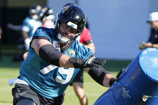 Jacksonville Jaguars center Luke Fortner performs a drill during practice at the team's NFL football training camp, Thursday, July 24, 2025, in Jacksonville, Fla. (AP Photo/John Raoux)