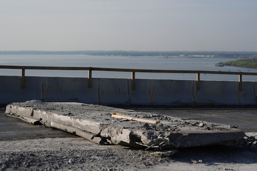 A slab of concrete is prepared to be removed from the remaining portions of the Francis Scott Key Bridge, Wednesday, July 30, 2025, in Baltimore. (AP Photo/Stephanie Scarbrough)