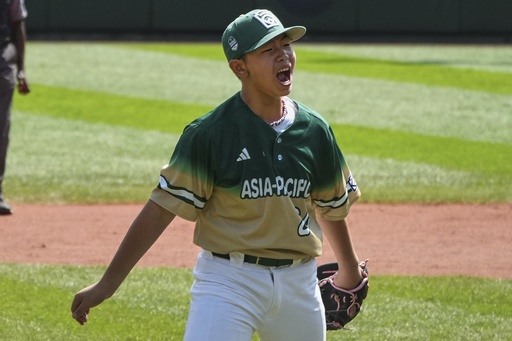 Taiwan's Chen Qi-Sheng (24) celebrates after getting the final out of the International Championship baseball game against Aruba at the Little League World Series tournament in South Williamsport, Pa., Saturday, Aug. 23, 2025. (AP Photo/Gene J. Puskar)