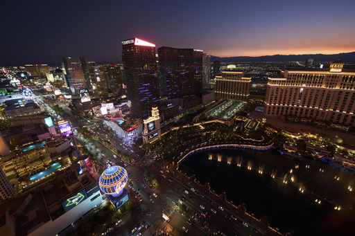 Cars drive along the Las Vegas Strip, Saturday, Aug. 2, 2025, in Las Vegas. (AP Photo/John Locher)