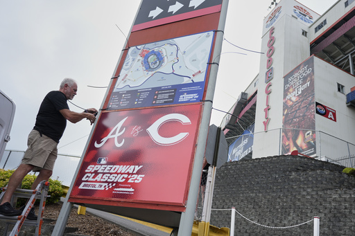 Rod Bruchell installs signs outside Bristol Motor Speedway, Friday, Aug. 1, 2025, in Bristol, Tenn., the day before the MLB Speedway Classic baseball game between the Cincinnati Reds and Atlanta Braves. (AP Photo/George Walker IV)
