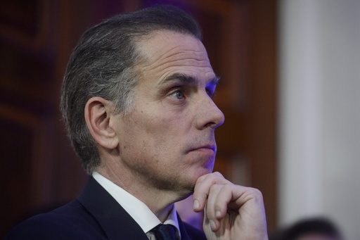 FILE - Hunter Biden listens while his father, President Joe Biden, speaks during a Hanukkah reception in the East Room of the White House in Washington, Dec. 16, 2024. (AP Photo/Rod Lamkey, Jr.)